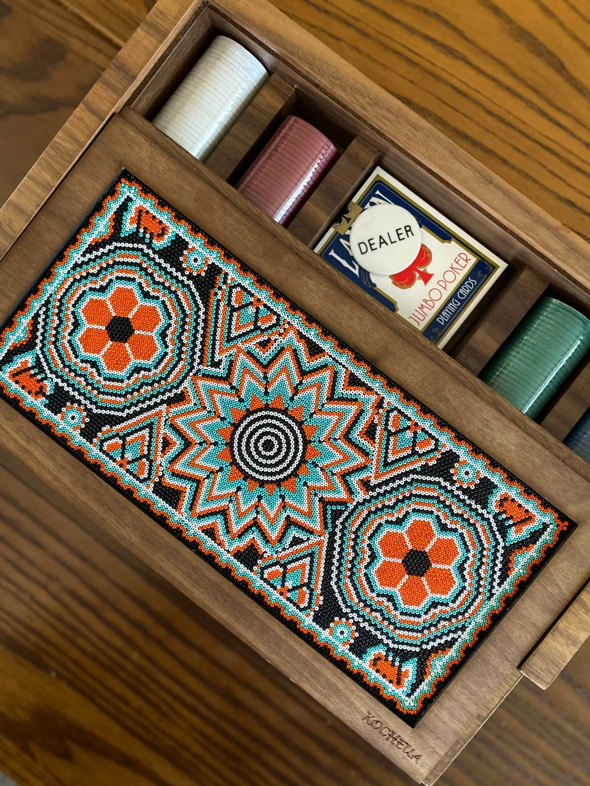 Wooden game box decorated with orange, turquoise and white Huichol beadwork in floral and geometric patterns